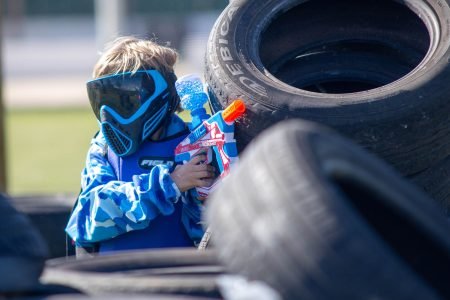 A young boy is hanging on the line in the rope park. Sports ente